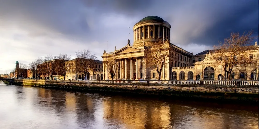 The Four Courts in Dublin beside the River Liffey at sunset